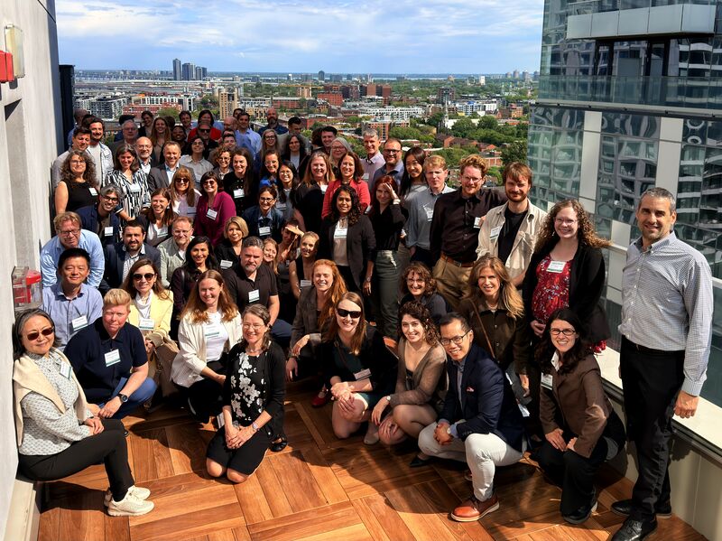 Group photo from CAGBC's Embodied Carbon Summit in Montreal, attendees gathered on a rooftop terrace overlooking the city.